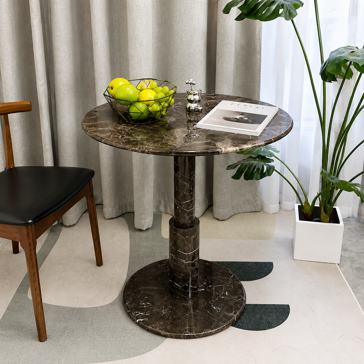 RoundTwin Elite dark marble dining table styled with greenery and warm interior decor