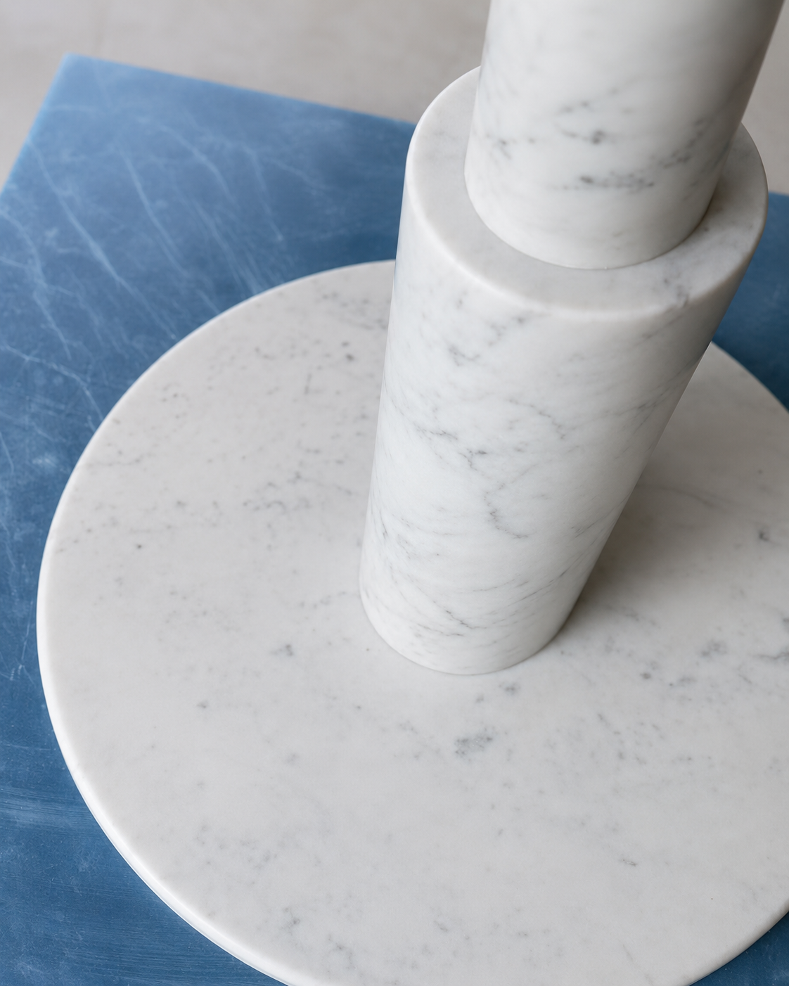 RoundTwin Elite Carrara marble dining table base detail with protective floor covering