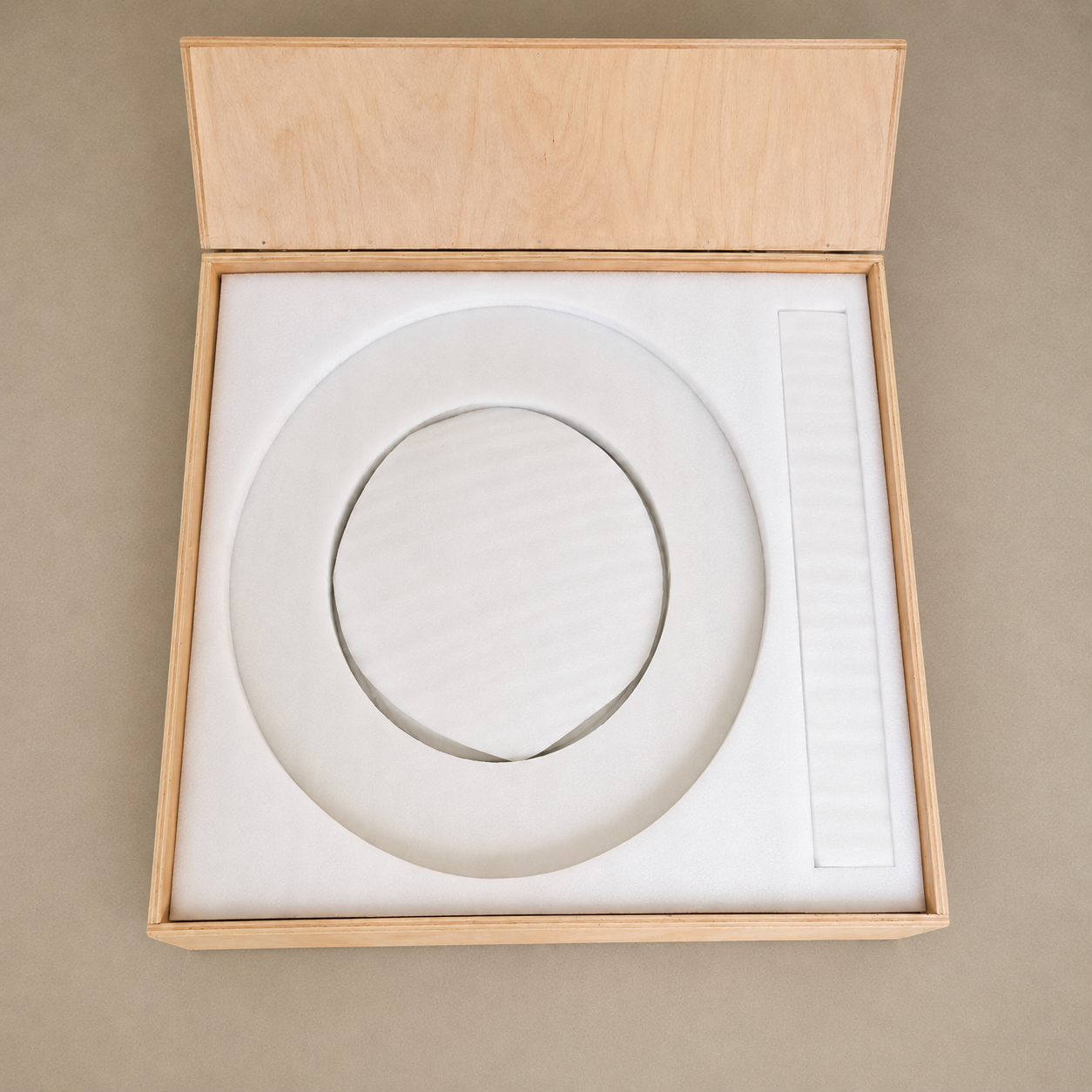 RoundTwin Elite black marble tabletop protected in wooden crate for shipping