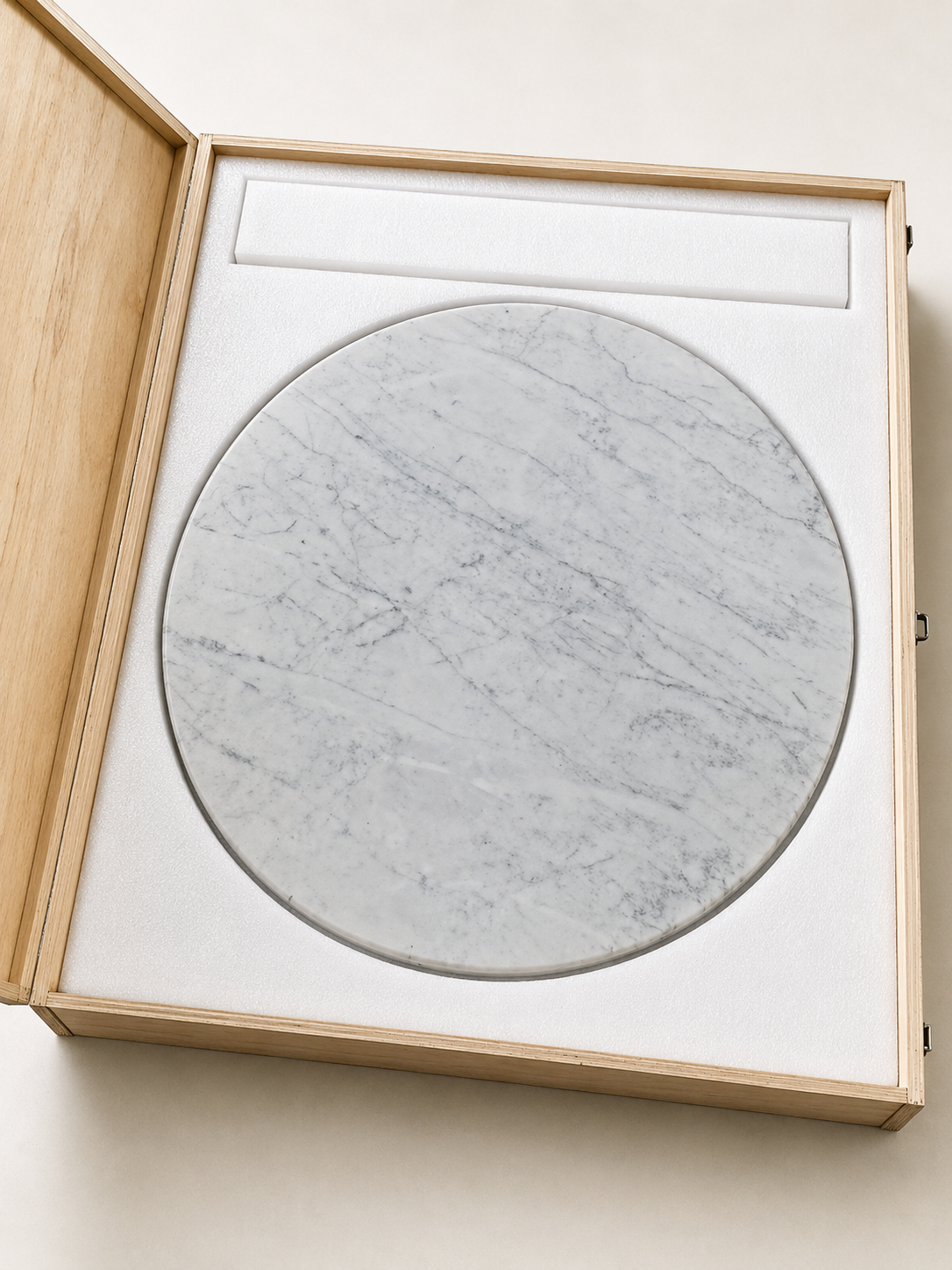 RoundTwin Elite Carrara marble tabletop protected in wooden crate for delivery
