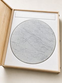 RoundTwin Elite Carrara marble tabletop protected in wooden crate for delivery