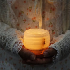 LumiGem Candle Holder - Featuring an Elegant Onyx Gemstone Design.  Premium Material: Crafted from luxurious white onyx gemstone, known for its unique veining and natural beauty. Elegant Design: Cup-shaped design that adds a touch of sophistication and modern elegance to any decor. Mesmerizing Glow: This creates a warm, enchanting light when a candle is placed inside, perfect for setting a romantic or cosy atmosphere.  Versatile Use: Ideal for living rooms, bedrooms, and dining areas or as a stylish centrep