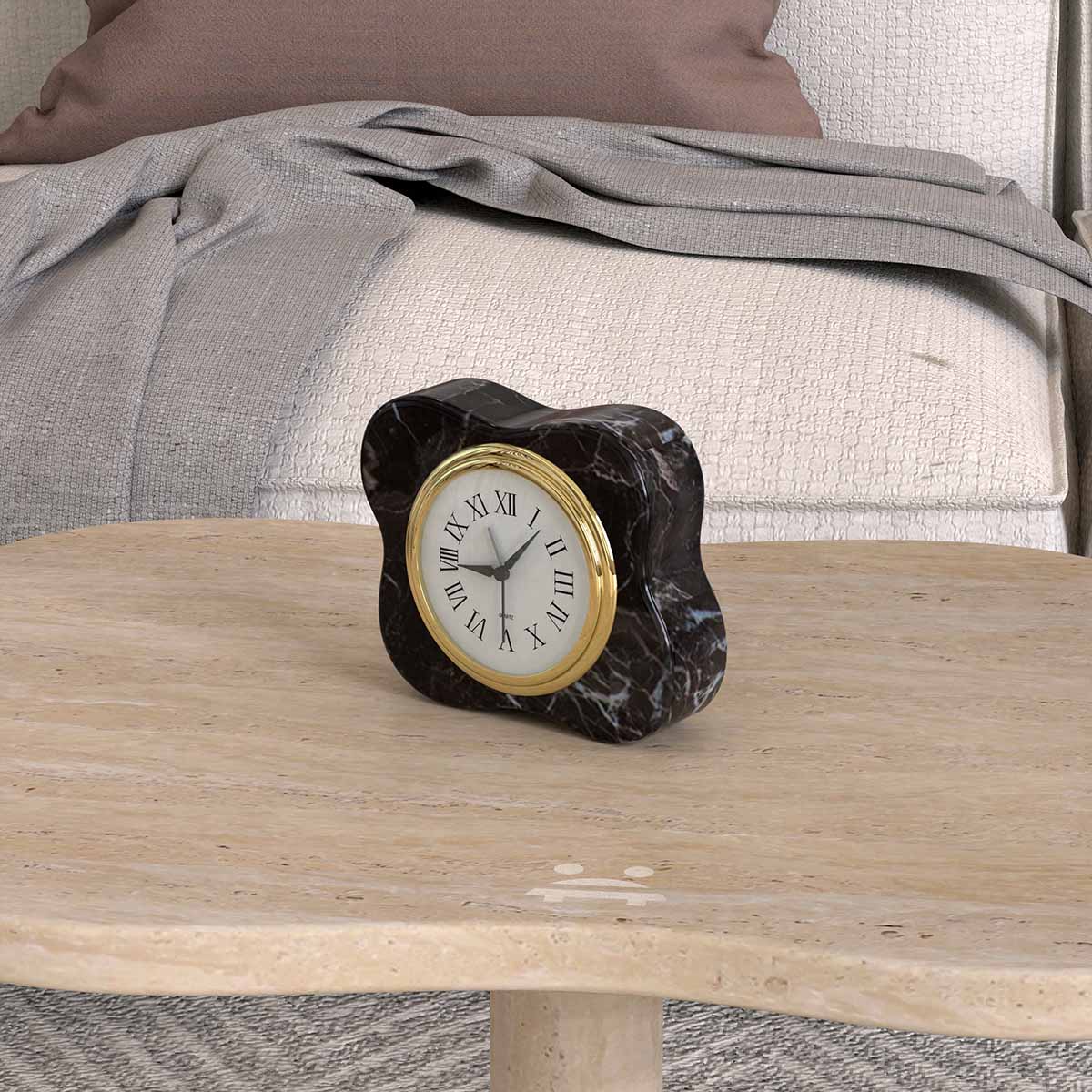 Angled view of the black marble LakeMist clock on a beige stone coffee table
