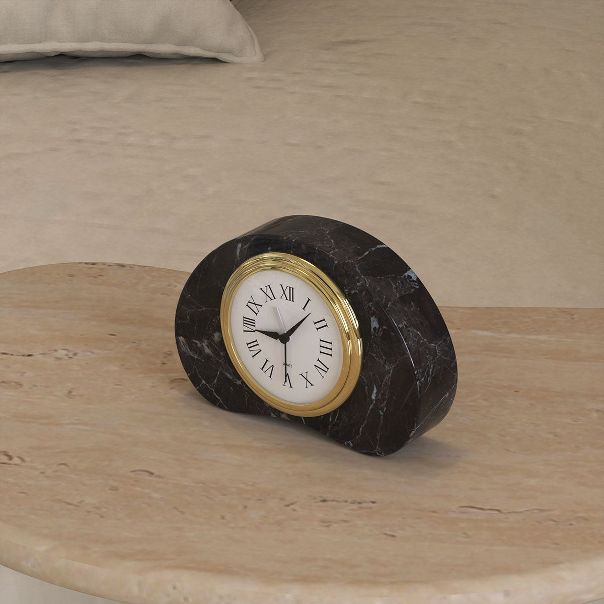 Black PeaPod Marble Clock on a bedside table, offering a luxurious and timeless aesthetic with its polished marble and gold-accented design.