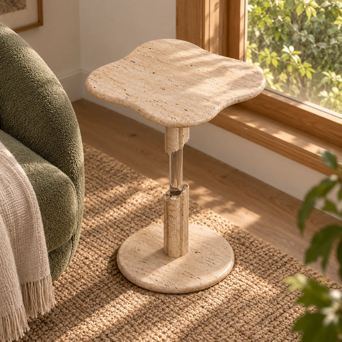 AeroCloud Classico travertine and acrylic side table in a window-side reading alcove, viewed from a higher oblique angle.