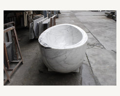 Celeste Ivory Cloud Marble soaking bathtub, real end view and sculptural bowl profile