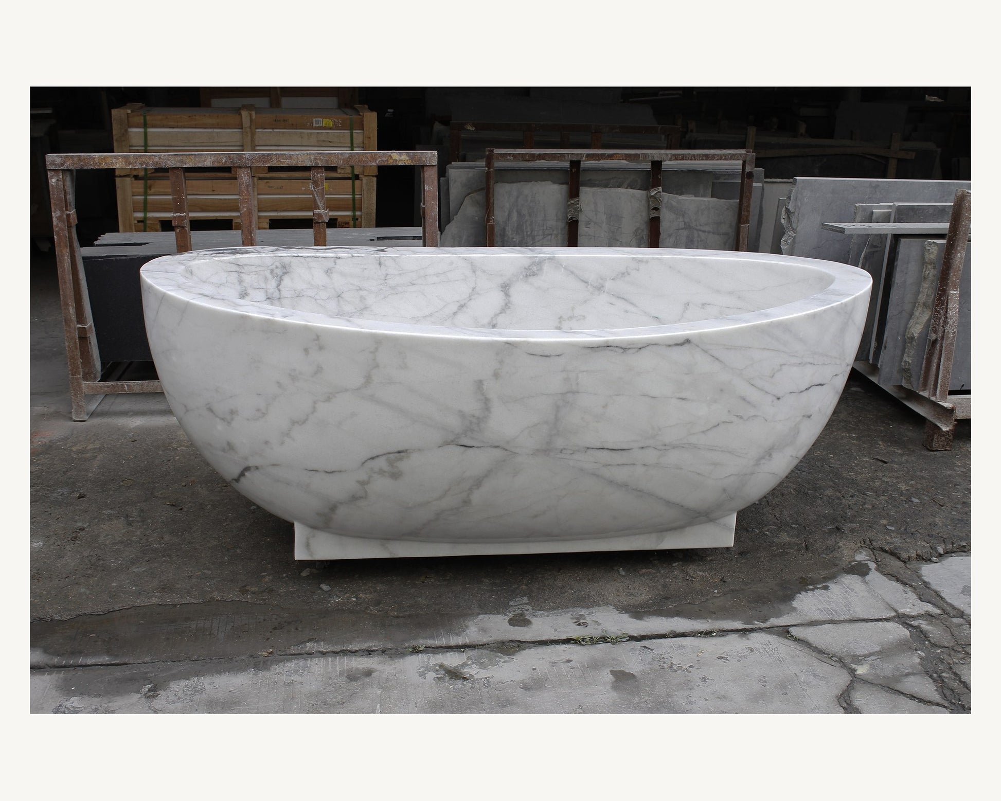 Celeste Ivory Cloud Marble soaking bathtub, real front view with pedestal base