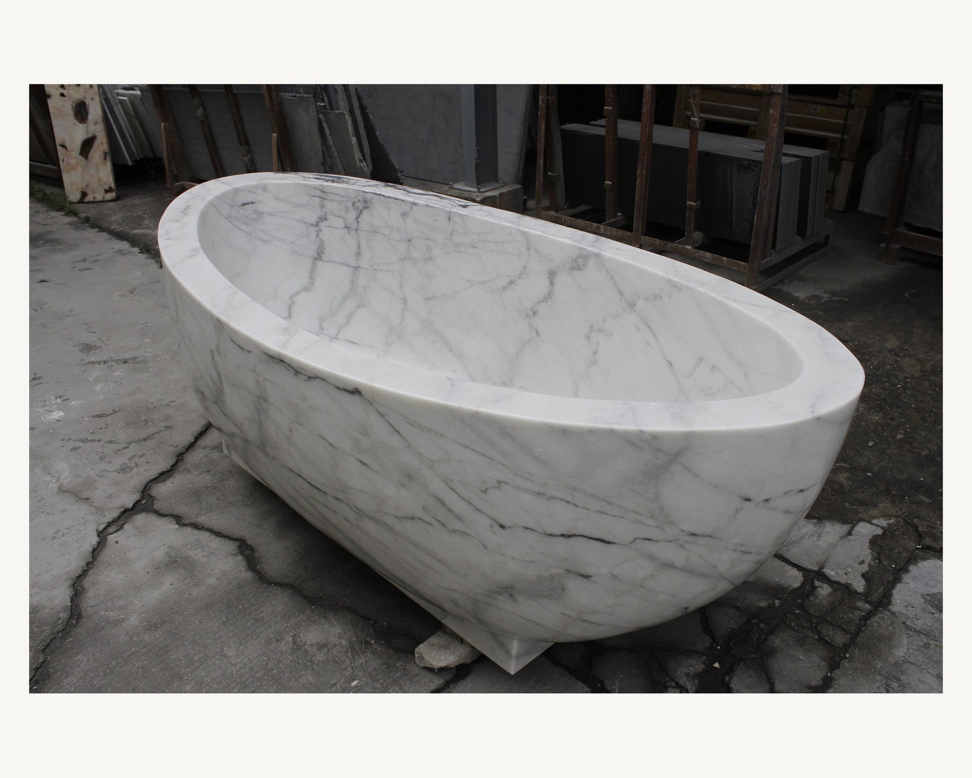 Celeste Ivory Cloud Marble soaking bathtub, real high-angle view of rim and interior