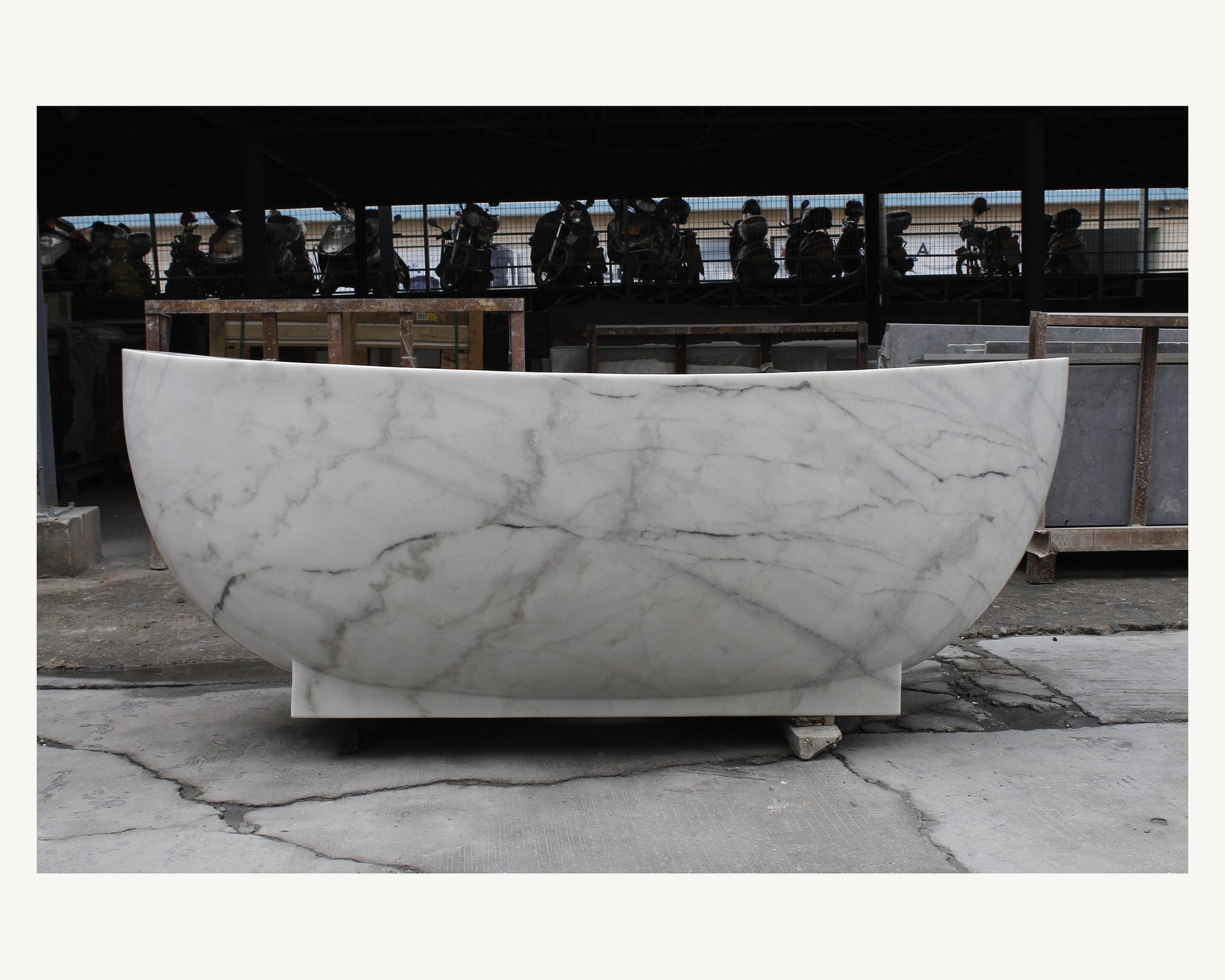 Celeste Ivory Cloud Marble soaking bathtub, real long-side profile and pedestal base