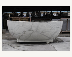 Celeste Ivory Cloud Marble soaking bathtub, real long-side profile and pedestal base