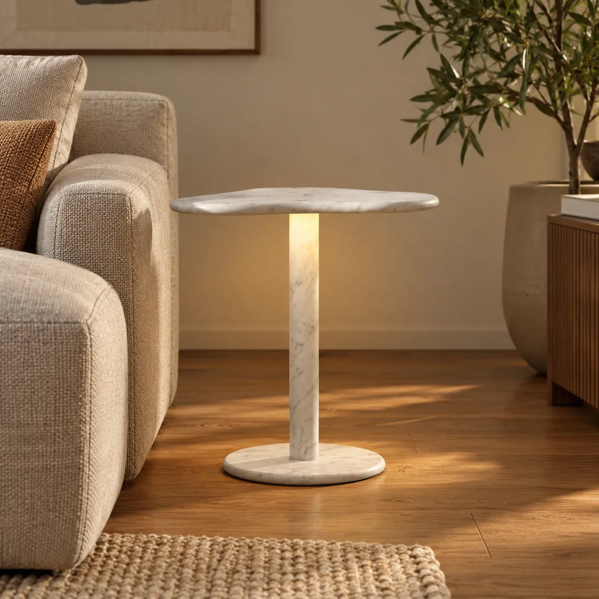 CloudDream Carrara marble smart-edition side table beside a sand linen sofa, shown from a low front view