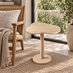 Elevated view of the CloudDream travertine side table in a garden-facing reading corner.