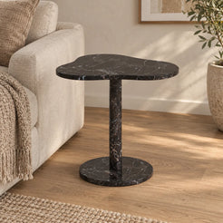 CloudDream Dark Emperador marble side table with a cloud-shaped top and circular base beside a linen sofa.