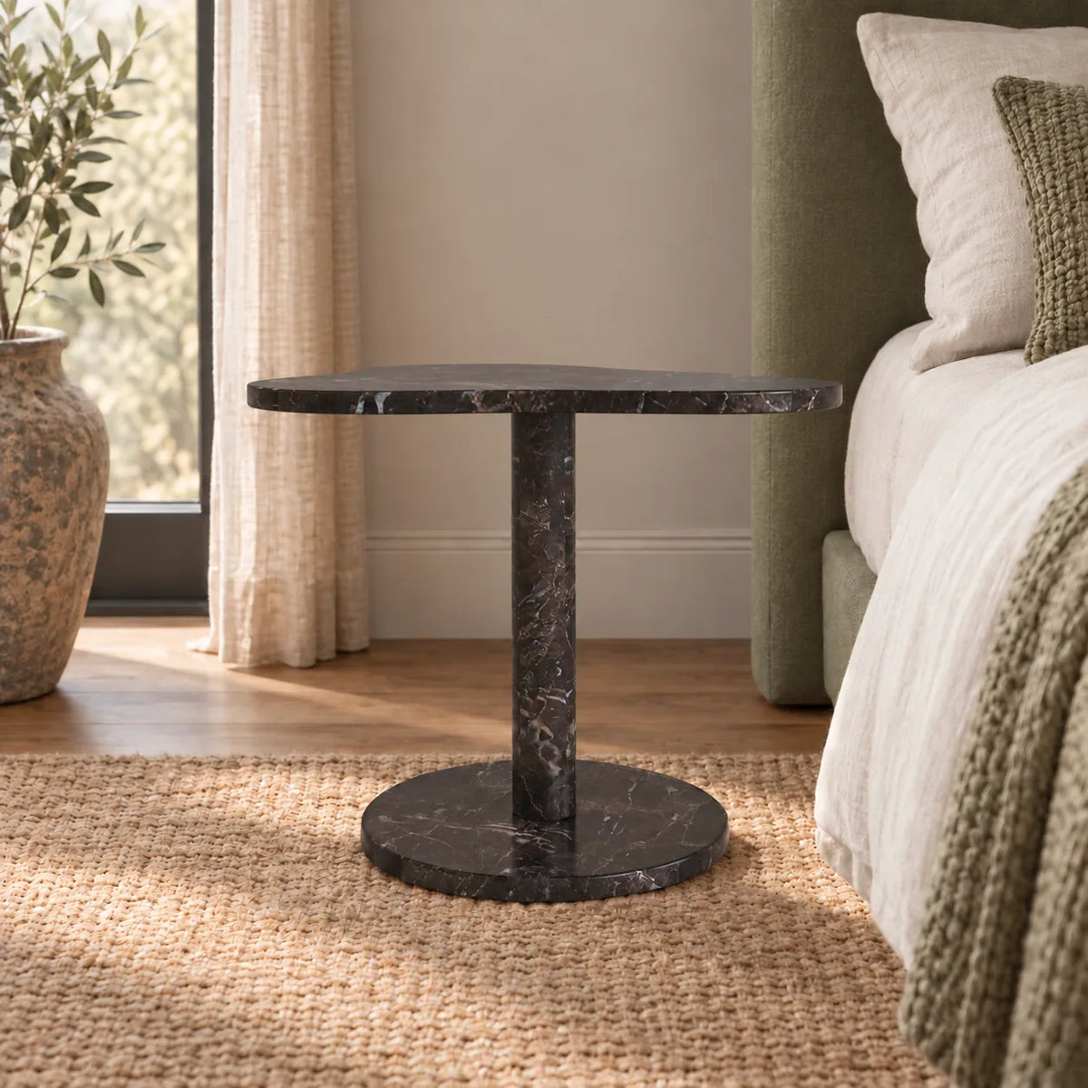 Low frontal view of the CloudDream Dark Emperador marble side table beside a timber bed.