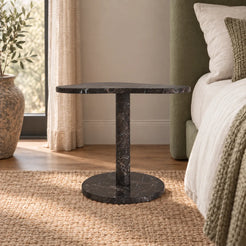 Low frontal view of the CloudDream Dark Emperador marble side table beside a timber bed.