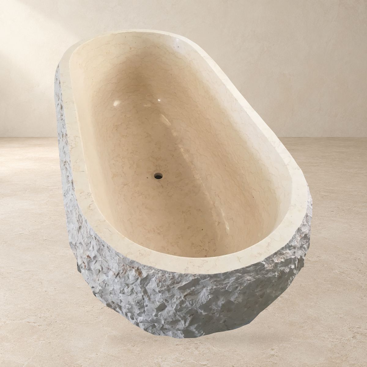 Dorienne BT-201A Golden Beige Marble bathtub, elevated end-view product photograph IMG_8665 with a replaced warm stone showroom background; original oval basin, circular drain, rim and rough-pick exterior retained.