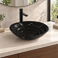 Illustrative low-angle bathroom vanity setting of the Eboni Portoro marble vessel sink