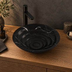 Illustrative lifestyle setting of the Eboni black Portoro marble bowl on an oak vanity