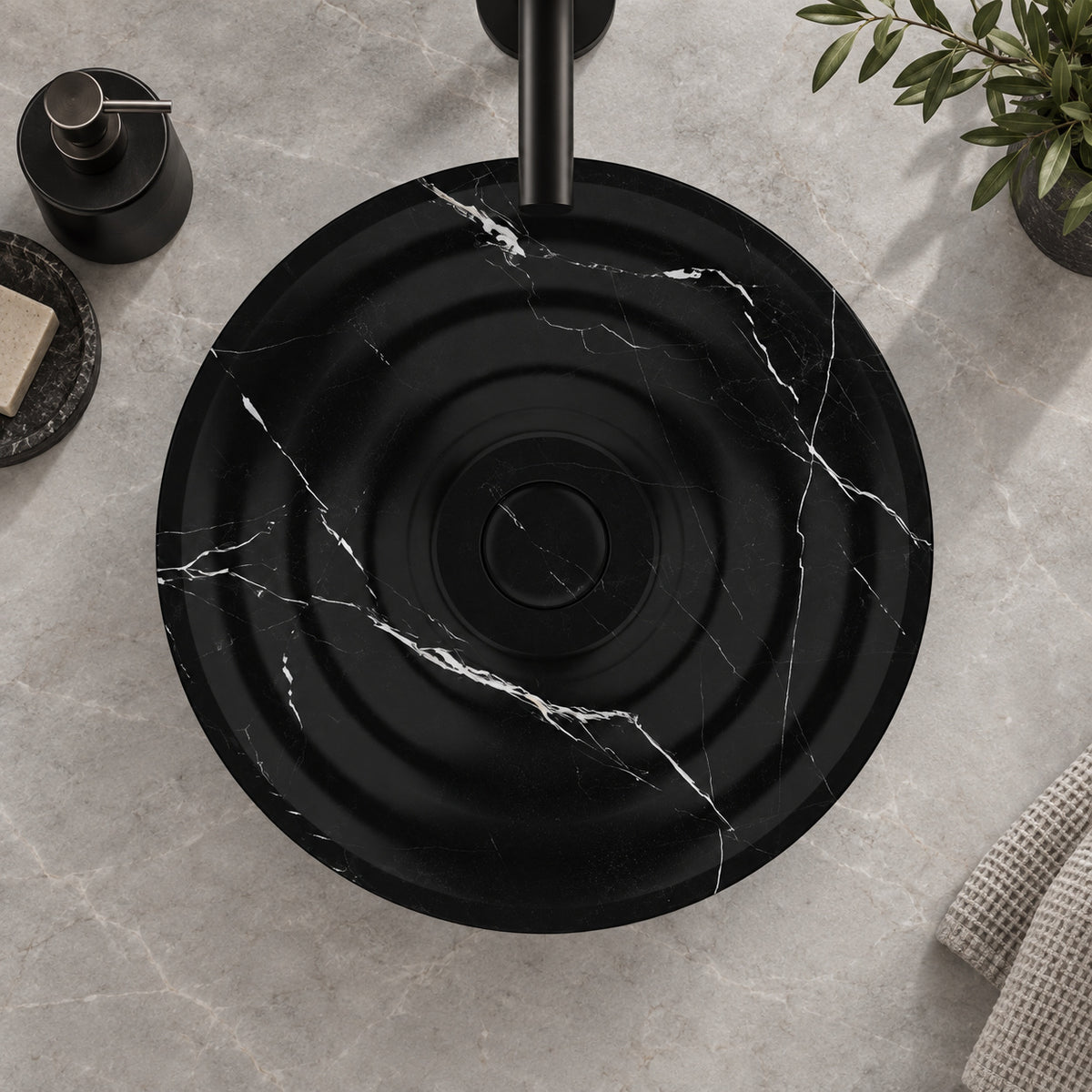 Illustrative overhead countertop setting showing the Eboni flowing circular rim and black drain cover