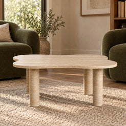 Low frontal view of the LakeMist travertine coffee table in an olive-chair reading corner.
