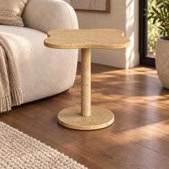 LakeMist Italian Classico travertine side table beside an ivory sofa, shown from a moderate oblique view