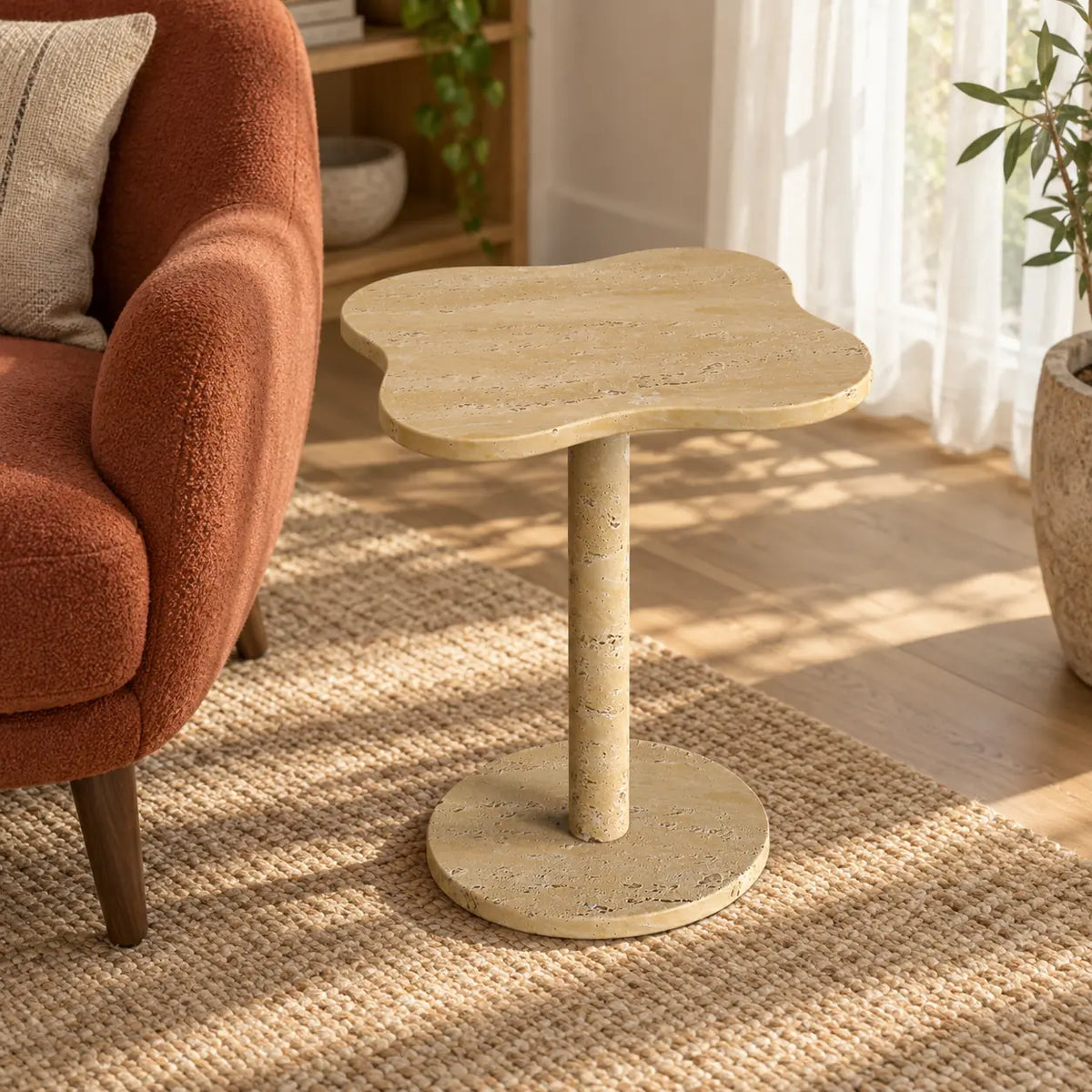 LakeMist Classico travertine side table in a window reading nook, shown from an elevated oblique view