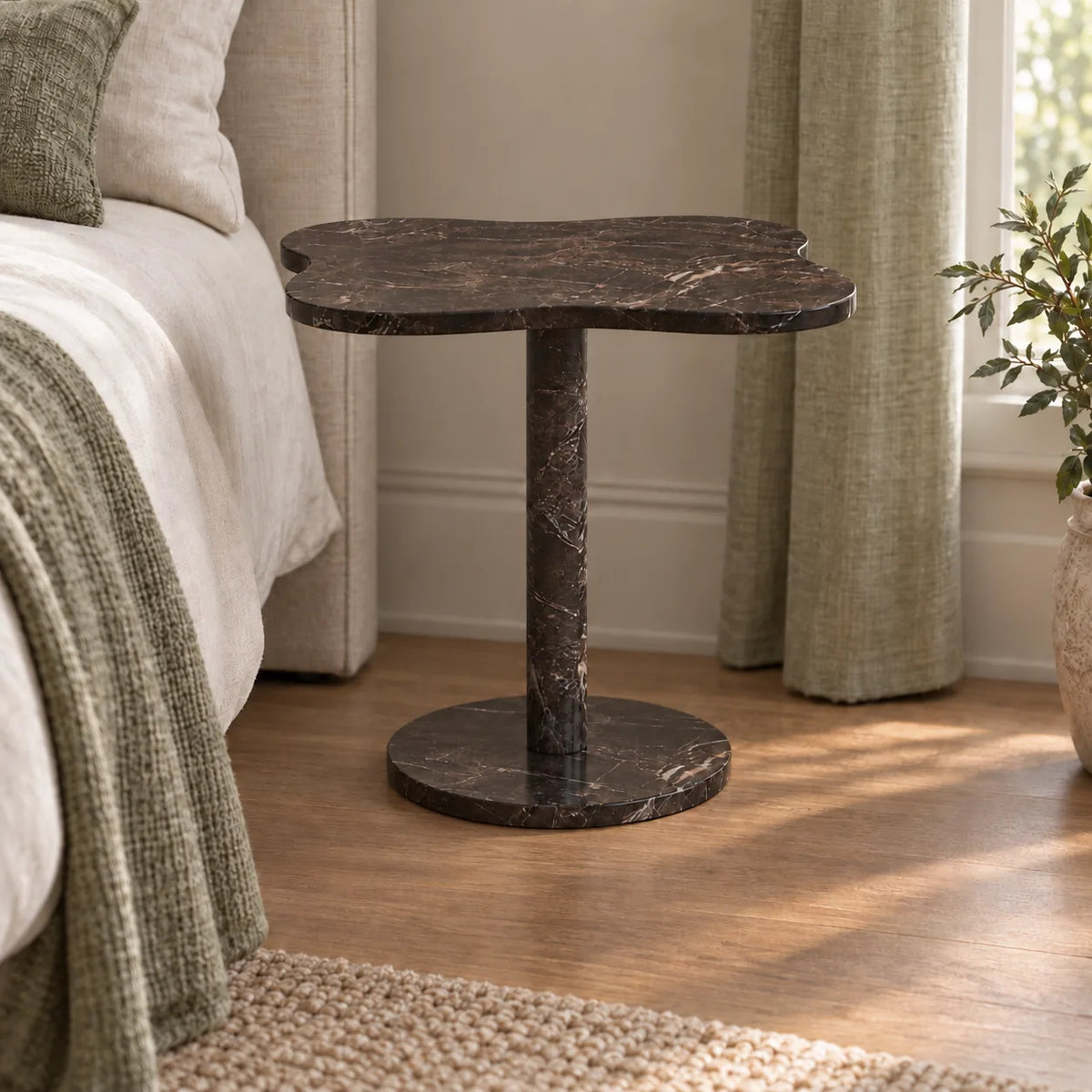 LakeMist Dark Emperador marble side table beside a bed, shown from a low frontal view