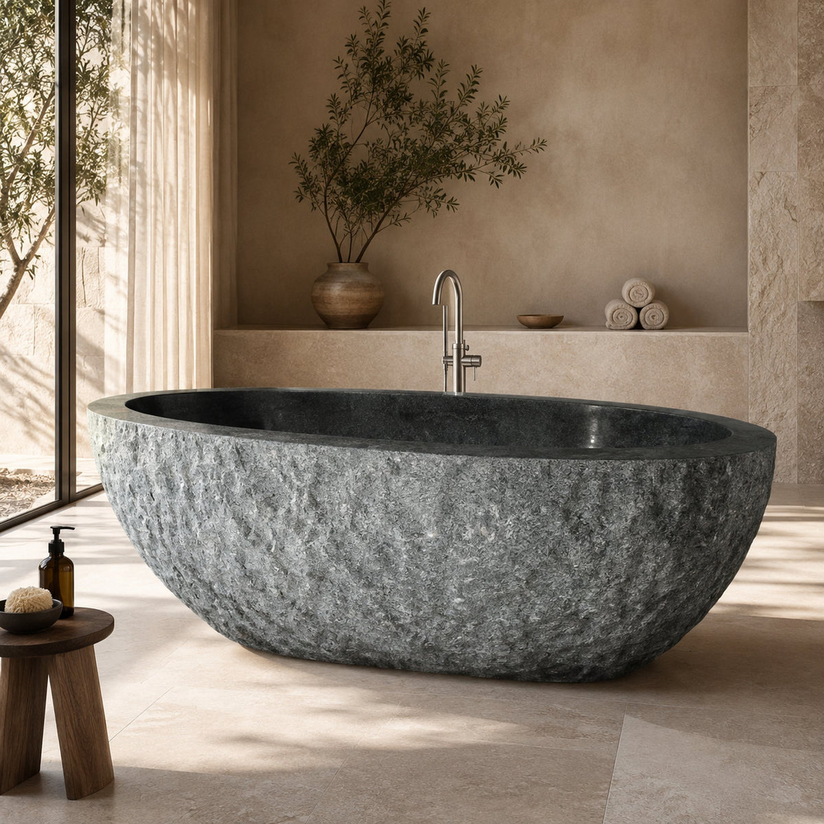 Noctelle Absolute Black Granite bush-hammer freestanding soaking bathtub in a warm luxury spa bathroom, styled visualization