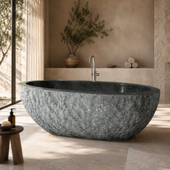 Noctelle Absolute Black Granite bush-hammer freestanding soaking bathtub in a warm luxury spa bathroom, styled visualization