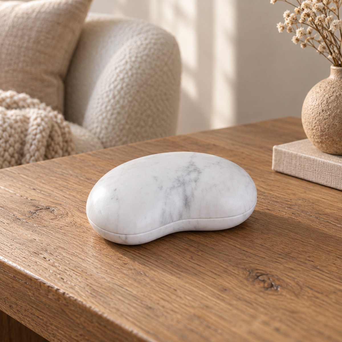 PeaPod white Carrara marble decor, low three-quarter view on a warm wood console