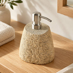 Rustic beige pebble-stone soap dispenser, opposite three-quarter view on a warm wood vanity