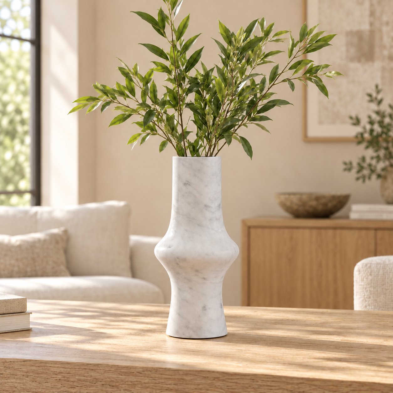 RoundHaven Carrara marble decorative vase, front view on a sunlit oak console
