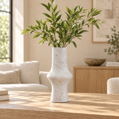RoundHaven Carrara marble decorative vase, front view on a sunlit oak console