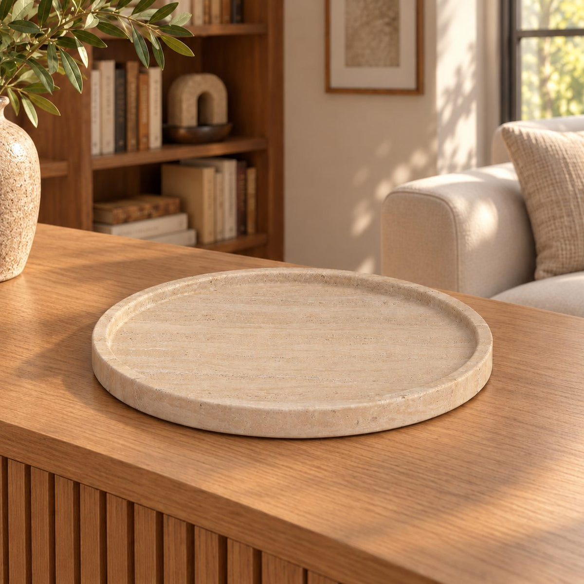 RoundHaven Classico travertine decorative tray, left oblique view in a warm natural-light interior