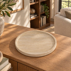 RoundHaven Classico travertine decorative tray, high right oblique view in a warm natural-light interior