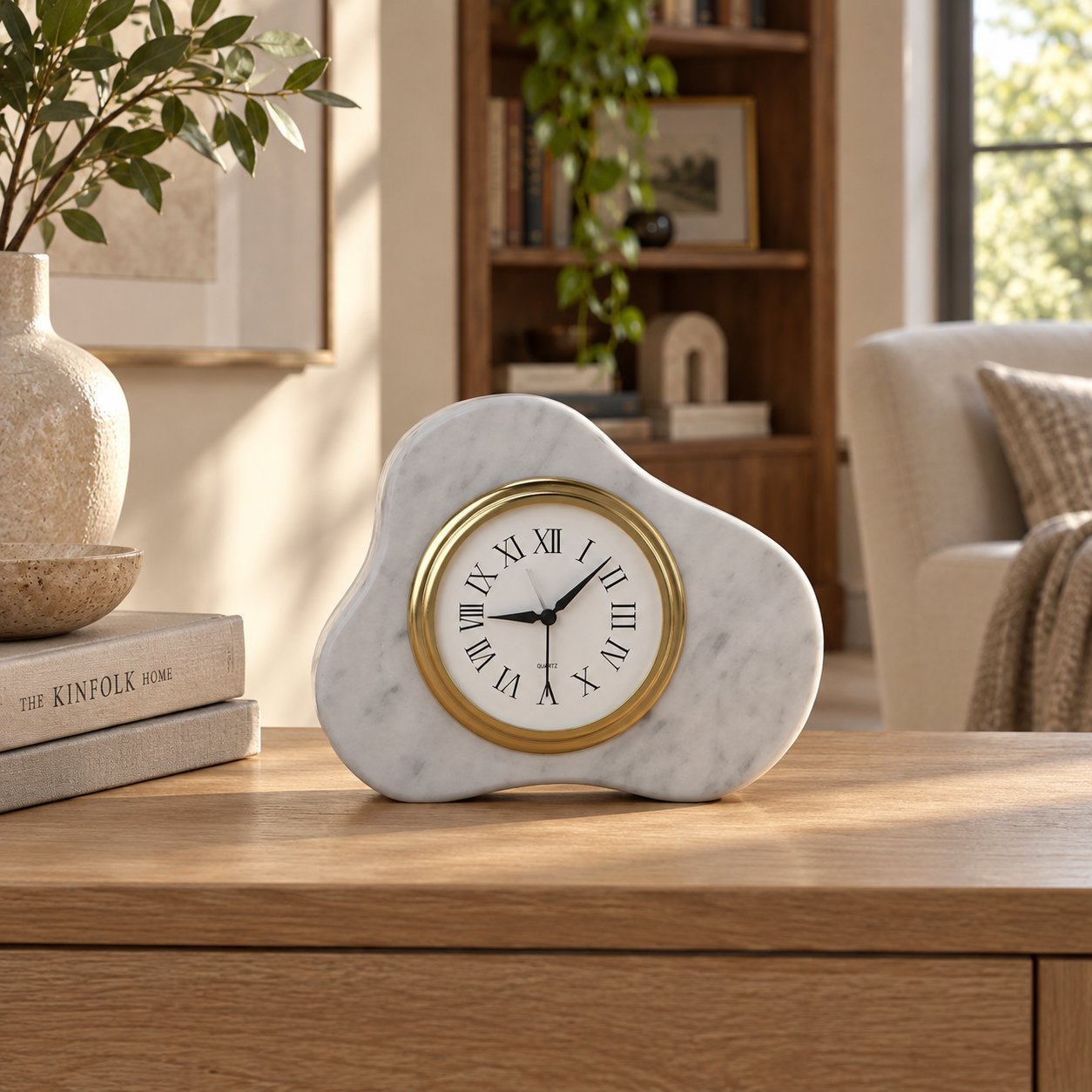 CloudDream Carrara marble tabletop clock, front view on a sunlit oak console
