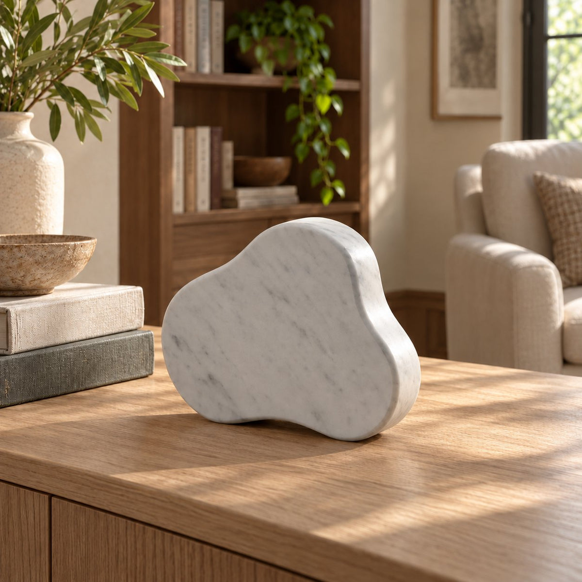 CloudDream Carrara marble tabletop clock, rear-right oblique view on a sunlit oak console