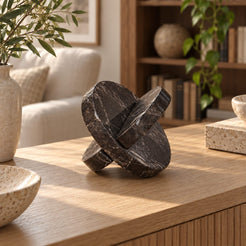 RoundHaven Spanish Emperador marble interlocking disc sculpture, right oblique view in a warm sunlit interior