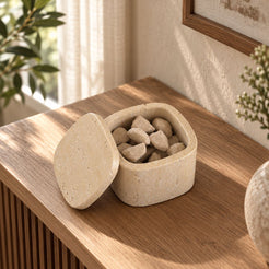 SquareSoft Classico travertine aroma diffuser with one matching rounded-square lid, left oblique view in a warm natural-light interior