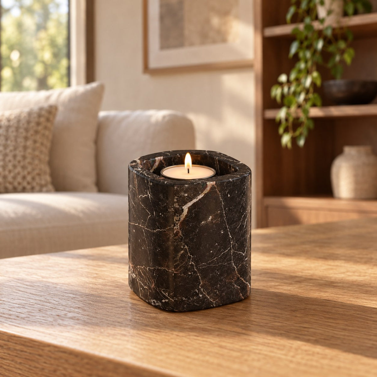Tall SquareSoft Spanish Emperador marble candle holder with one lit tealight, front view in a warm natural-light interior