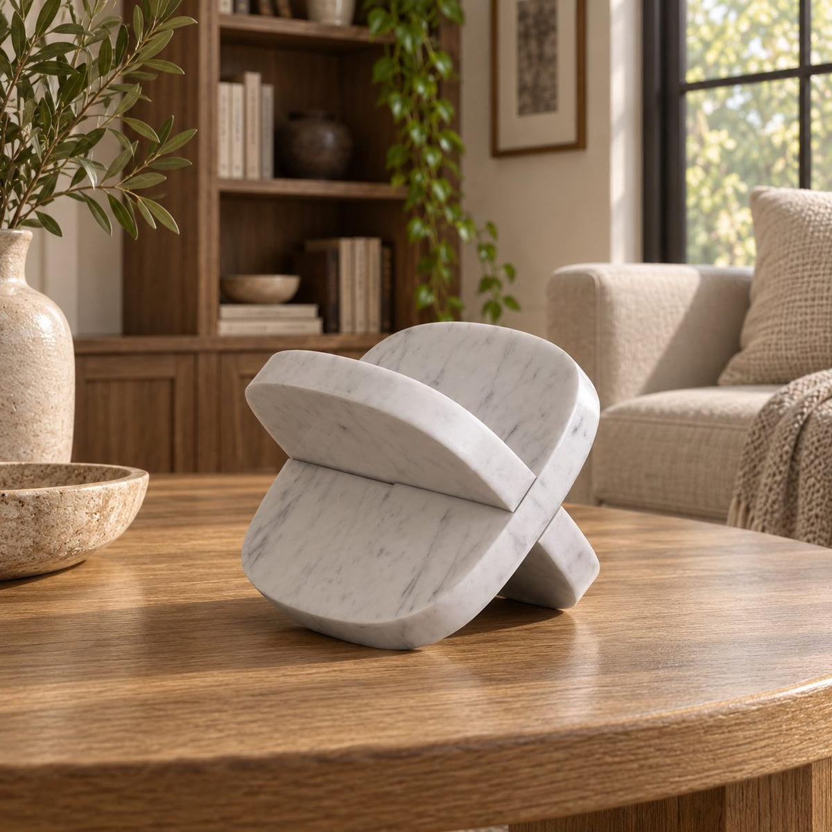 SquareSoft Carrara marble interlocking soft-square sculpture, front view in a warm naturally lit room