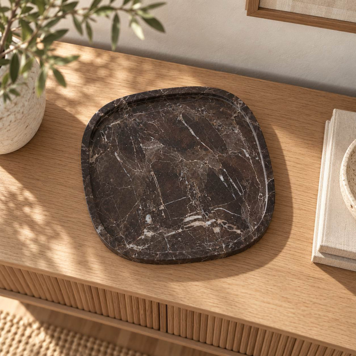 SquareSoft Spanish Emperador marble decorative tray, near-overhead view on a warm oak console