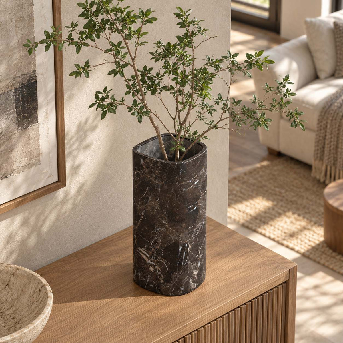 SquareSoft Spanish Emperador marble decorative vase, elevated opposite oblique view in a warm naturally lit interior