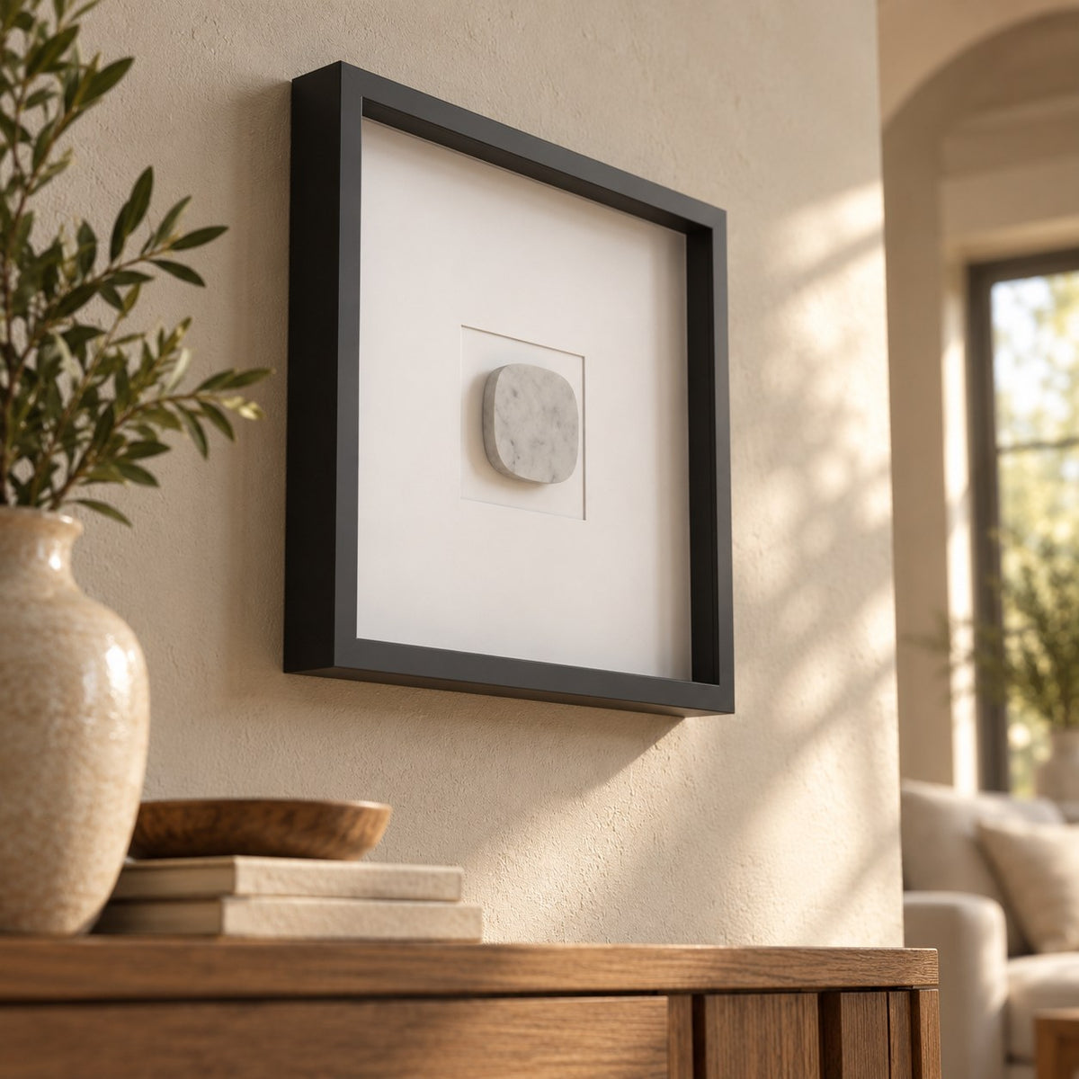 SquareSoft Italian Carrara marble wall frame decor, elevated opposite oblique view in a warm naturally lit interior