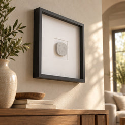 SquareSoft Italian Carrara marble wall frame decor, elevated opposite oblique view in a warm naturally lit interior