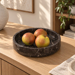 RoundHaven Spanish Emperador marble fruit tray, oblique view in a warm naturally lit interior