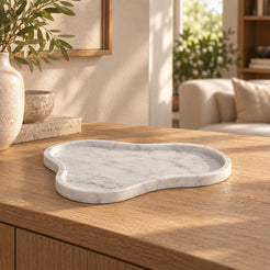 CloudDream Italian Carrara marble decorative tray, low front view in a warm naturally lit interior
