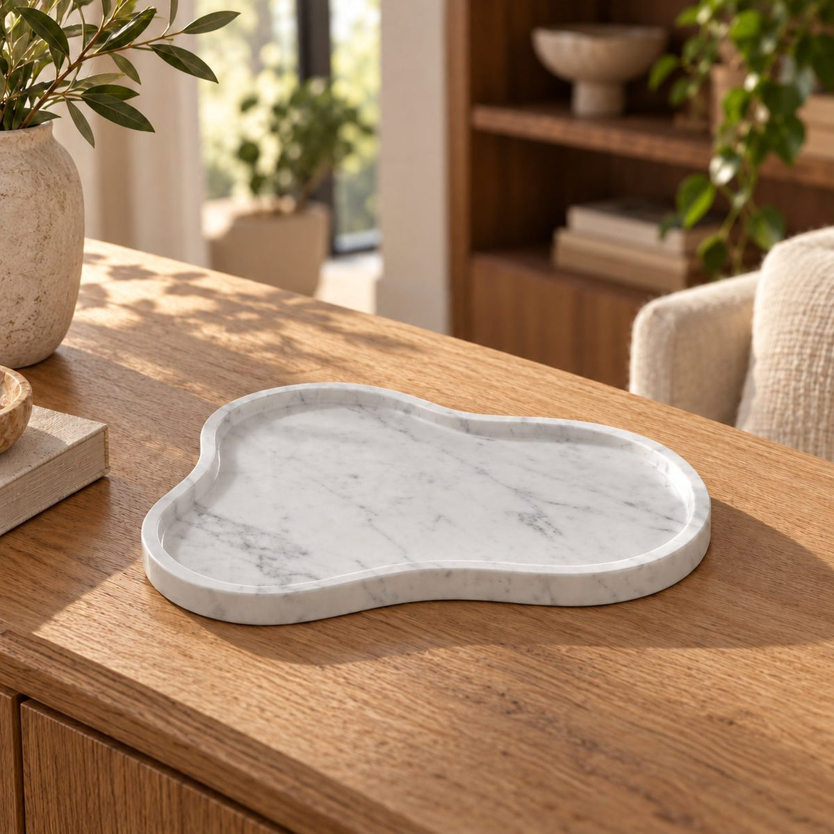 CloudDream Italian Carrara marble decorative tray, oblique view in a warm naturally lit interior