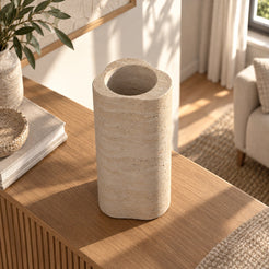 CloudDream Decorative Vases, Italian Classico Travertine, Third photograph from high opposite RIGHT diagonal, camera elevated65 degrees, show round inner opening within cloud top profile and tall wall; true changed camera perspective, not same view new background., warm natural light lifestyle
