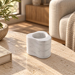 CloudDream Tall Carrara marble candle holder, left oblique view in a warm natural-light interior